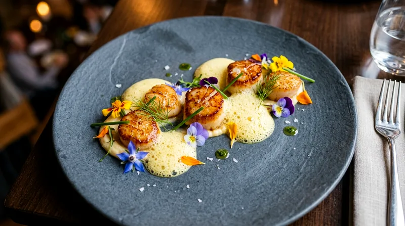 Fine-dining seafood course with edible flowers and foam garnishes