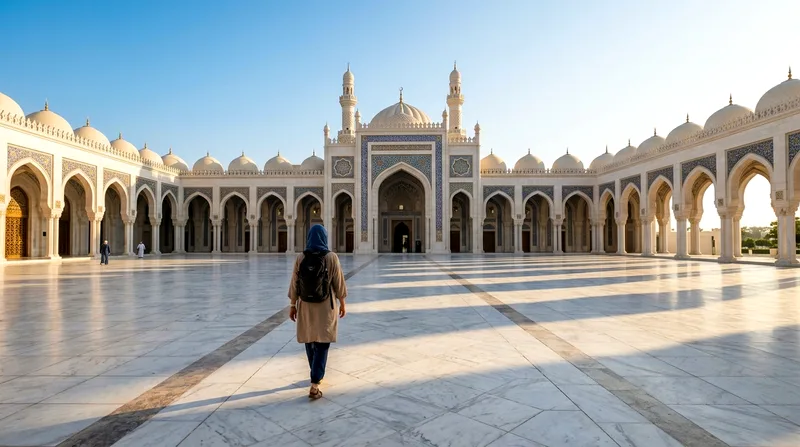 Solo traveler walking into Sheikh Zayed Grand Mosque courtyard at dawn