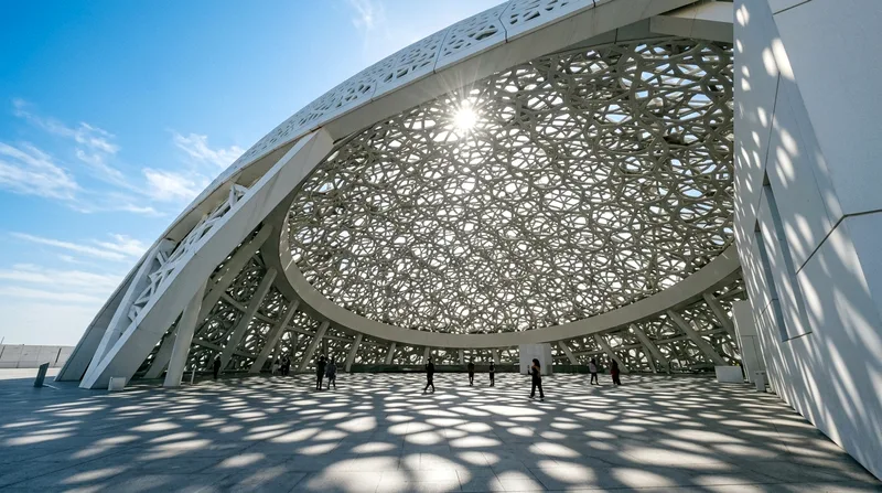Louvre Abu Dhabi's perforated white dome casting light patterns